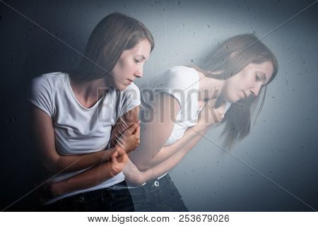 Young woman suffering from a severe depression/anxiety (color toned image; double exposure technique is used to convey the mood of unease, progression of the anxiety/depression)