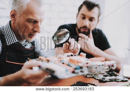 Two Men Repairing Hardware Equipment From Pc. Repair Shop. Worker With Tools. Computer Hardware. You