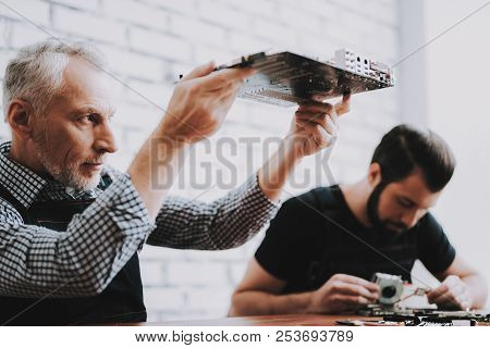 Two Men Repairing Hardware Equipment From Pc. Repair Shop. Worker With Tools. Computer Hardware. You