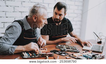 Two Men Repairing Hardware Equipment From Pc. Repair Shop. Worker With Tools. Computer Hardware. You