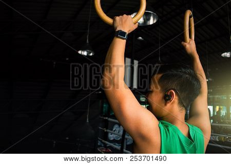 Asian Man Athlete Gymnast Rings Exercise In Gymnastics Exercise Chest 
Workout On Bench Press Cable 