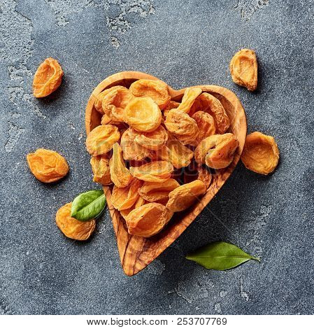 Dried Apricots On Gray Concrete Background. Top View.