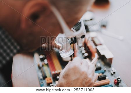 Close Up. Old Man Repairing Motherboard From Pc. Repair Shop. Worker With Tools. Computer Hardware. 