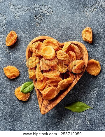 Dried Apricots On Gray Concrete Background. Top View.