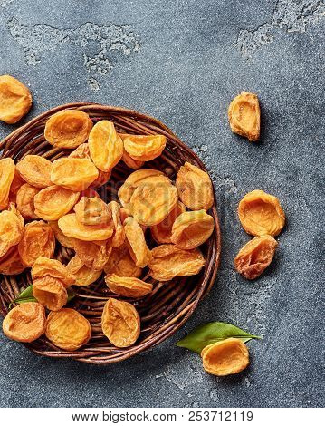 Dried Apricots On Gray Concrete Background. Top View.