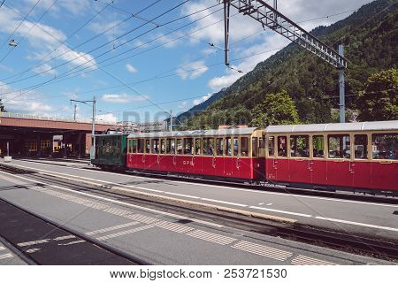 Wilderswil, Bernese Oberland, Switzerland - August 5, 2017 : Retro Passenger Train Arrives In The Wi