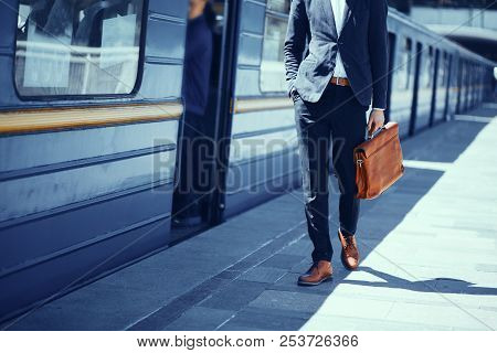 Businessman Standing At Subway Platform. Elegant Guy In Formal Suit And Brown Leather Shoes Standing