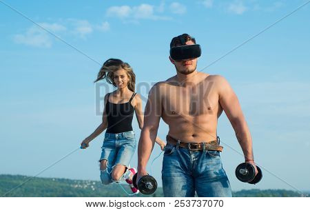 Strong Man With Musucular Torso And Fit Woman Skipping. Strong Sportsman Use Smart Technology For Bu