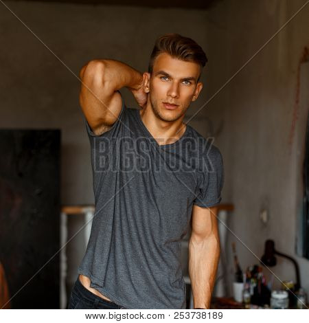 Fresh Portrait Of A Beautiful Model Man In A Gray T-shirt In The Studio