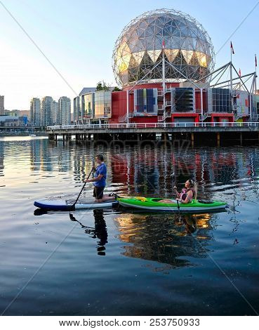 Active Married Couple Boating And Kayaking In City Harbor False Creek Near Yaletown. Summer Vacation