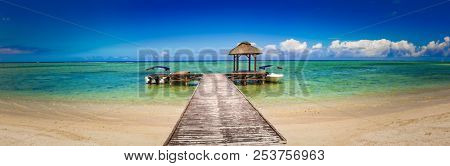 Sandy tropical Wolmar beach at sunny day. Jetty on the foreground. Beautiful landscape panorama. Mauritius