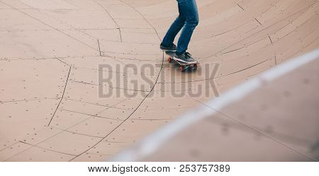 One Woman Skateboarder Sakteboarding On Skatepark Ramp