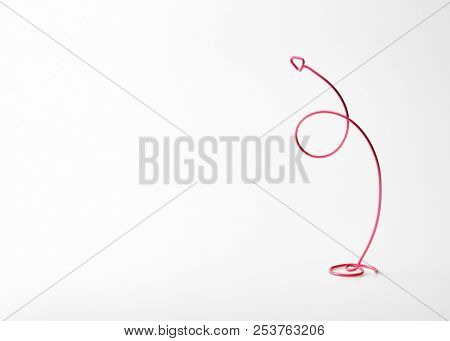 Going up or upward. arrow spiraling upward for something increasing. Red wires forming a upward arrow. Plenty of copy space on left. (flip image for reversed space). Good presentation background.  