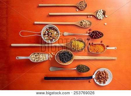 Healthy Diet Concept.top View Of Fflat Lay Of Assortment Of Legumes On Orange Tabletop Background, I