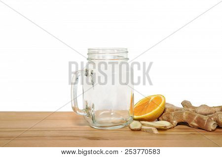 Ingridientes For Tonifying Smoothie With An Empty Mason Jar On A Wooden Cutting Board With White Bac