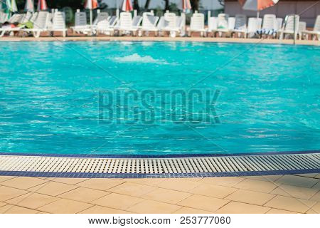 Water Swimming Pool. Pool With Blue Water. Background Of Clean Blue Rippled Water In A Hotel Swimmin