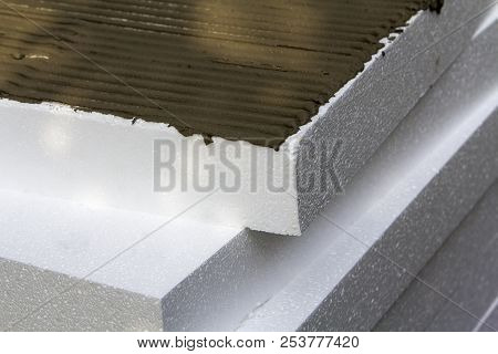 Close-up Detail Of Stack Of White Rigid Polyurethane Styrofoam Sheets With Applied Glue For House In