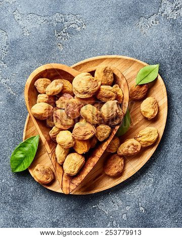Sun Dried Apricots On Gray Concrete Background. Top View.
