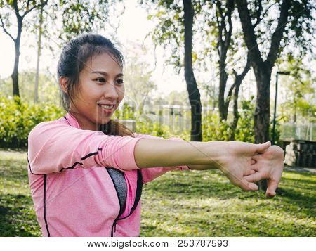 Close Up Of A Young Woman Warm Up Her Body By Stretching Her Arms To Be Ready For Exercising And Do 