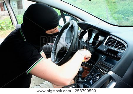 The Malefactor In The Mask Stealing Car