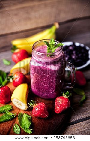 Blueberry Smoothies On A Wooden Background With Fruits. Vitamins A