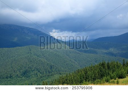 Low Grey Clouds In The Mountain Valley, Green Forest, Black Mountains