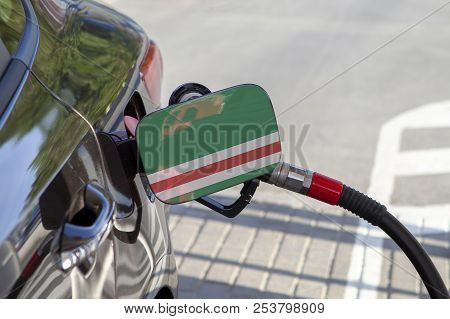 Fueling Car With Petrol Pump At A Gas Station.