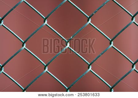 Close-up Of Isolated Painted Simple Geometric Black Iron Metal Wire Chain Link Fence Eon Dark Red Ba
