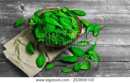 Fresh Green Leaves Mini Spinach In Ceramic Bowl. Spinach Leaves On The Gray Wooden Rustic Background