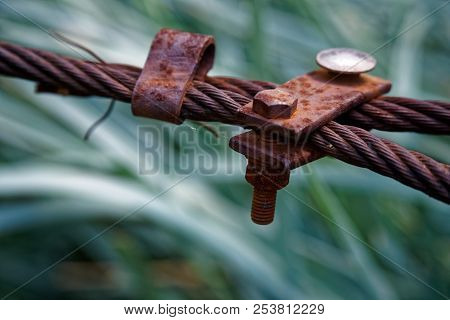 Thick Steel Rope Close Up. Bridge Fence Element. Detailed View. The Surface Of The Steel Cable Is Co
