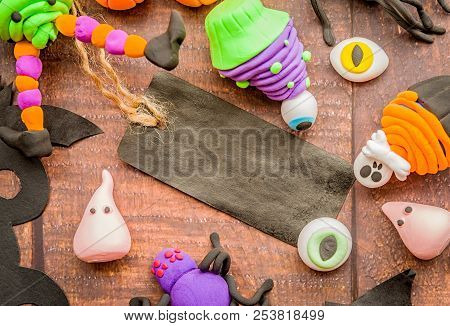 Halloween Concept. Symbols And Decorations Made Of Polymer Clay On Wooden Table Flat Lay Top View