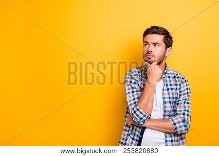 Close Up Portrait Of Thoughtful Man Who Looks Away Touching His Chin And Weighs The Pluses And Minus