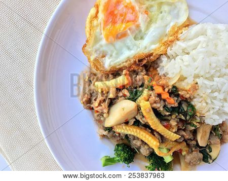 Stir Fried Minced Pork With Basil Eating With Rice And Fried Egg On White Background. Thai Food.
