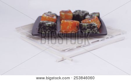 Different Types Of Maki Sushi On A Black Plate