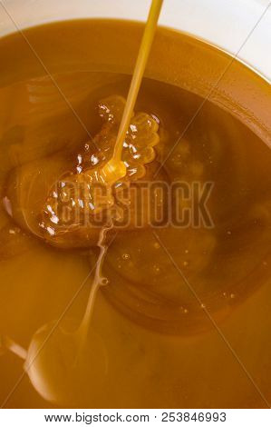 Honey Liquid Background Macro Closeup. Helth Food