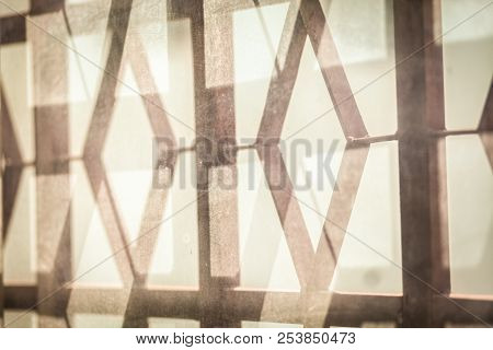The Grille On The Diamond Shape Window, The Play Of Light And Shadow, The Warm Tones Of A Sunny Day 