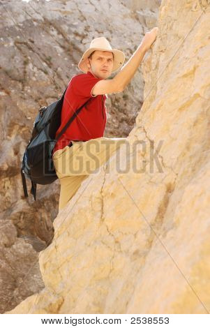 Adult Man Climbing On Rock