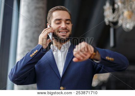 A Man Is Checking The Time.business Concept