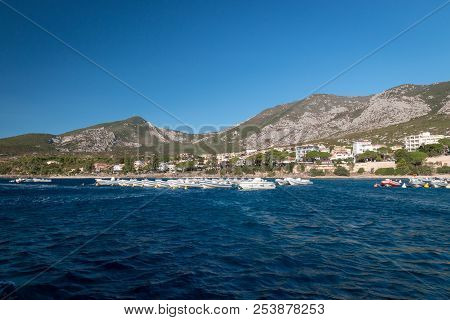 Panoramic View Of Cala Gonone With Many Rental Boats In The Water On The Italian Island Of Sardinia