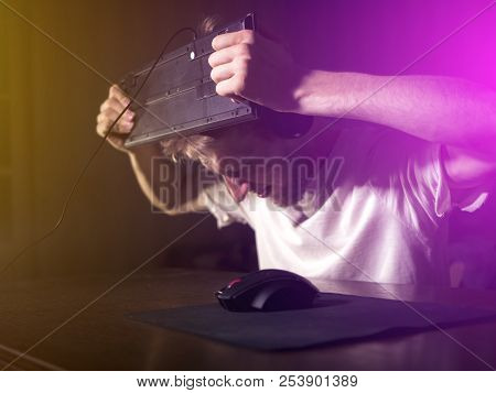 Young Bearded Man Going Crazy Mad And Crashing Breaking The Computer Keyboard Using His Head Late In