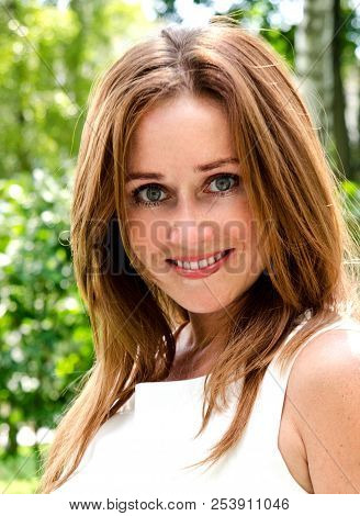 Portrait Of Prety Smiling Young Woman Outdoors In Summer Day