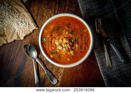 Healthy Farro Vegetable Soup On Rustic Wooden Table