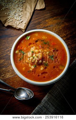 Healthy Farro Vegetable Soup On Rustic Wooden Table