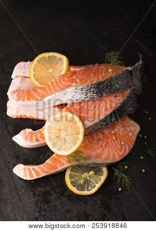 Raw Salmon Fish Fillet On Black Background