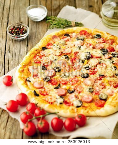 Homemade Lagge Pizza With Parmesan, Oregano, Olives And Mozzarella, Sausage And Tomato Sauce, Side V
