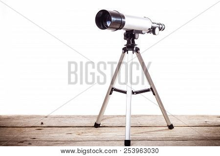 Telescope On A White Background Laid On Wooden Board