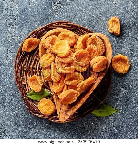 Dried Apricots On Gray Concrete Background. Top View.