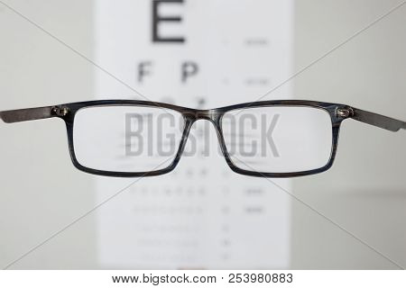 Close-up Of Eyeglasses For Vision, Pointing At Table To Check View. The Concept Of Poor Vision, Blin