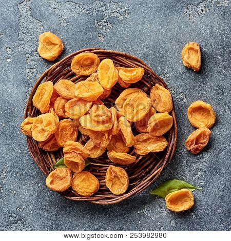 Dried Apricots On Gray Concrete Background. Top View.
