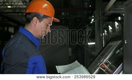 Operator Monitors Control Panel Of Production Line. Manufacture Of Plastic Water Pipes Factory. Proc